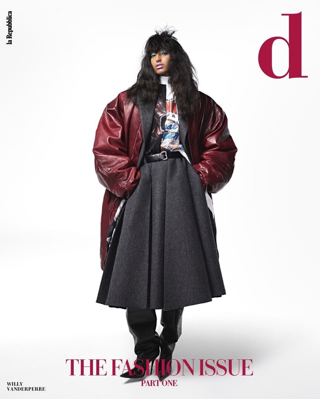 A fashion magazine cover features a model wearing a burgundy coat, grey skirt, and black boots, set against a bright white backdrop.