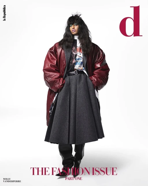 A fashion magazine cover features a model wearing a burgundy coat, grey skirt, and black boots, set against a bright white backdrop.