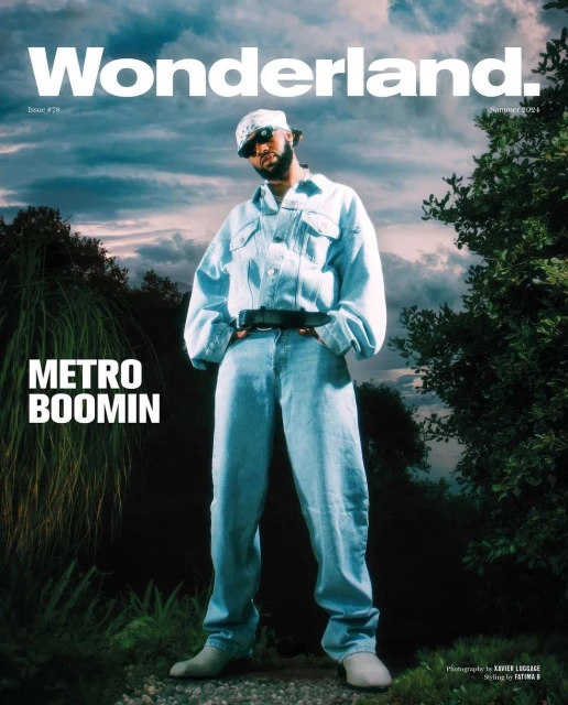 Metro Boomin on Wonderland cover, wearing a denim outfit with a bandana, set against an outdoor backdrop with trees and cloudy sky.