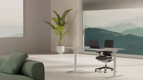 Minimalist workspace featuring a laptop and chair at a white desk, complemented by a large potted plant and a serene mountain view.