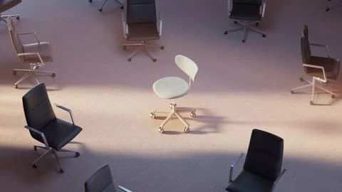 Overhead shot showcases a circle of office chairs, with one unique white chair at the center, arranged on a neutral-toned floor.