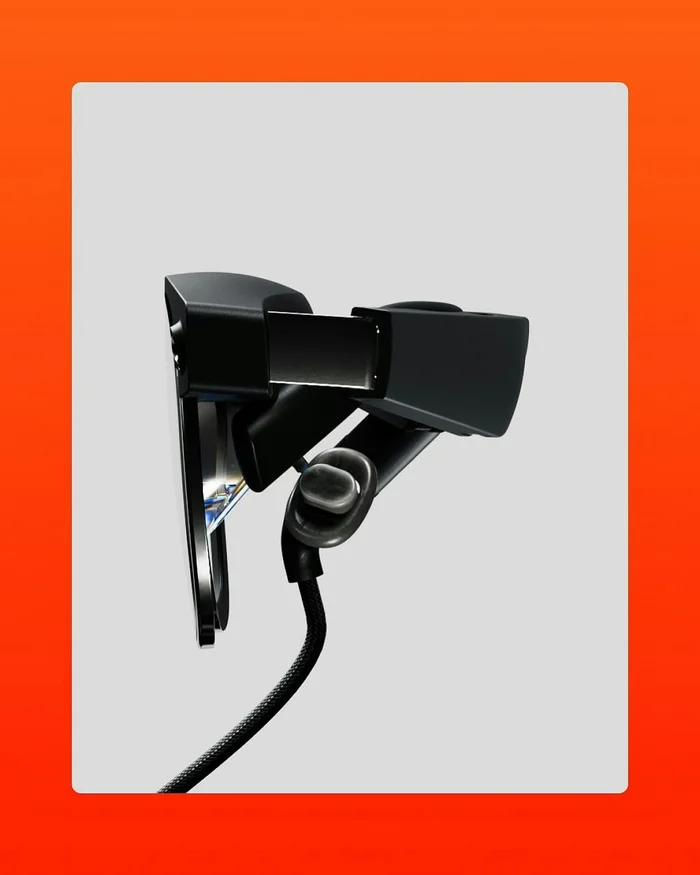 CGI rendering of black virtual reality headset with attached cable against a light grey background and bright orange border.