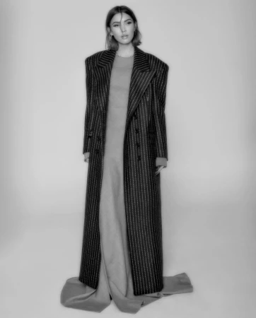 Model in a pinstripe coat and long dress photographed by Yana Yatsuk in New York