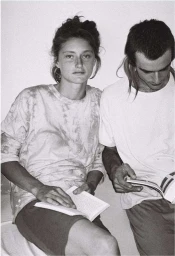 Black and white portrait of a woman and a man sitting together reading books