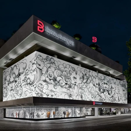 Exterior of Breuninger store at night featuring a large black-and-white mural and illuminated signage with the brand logo.