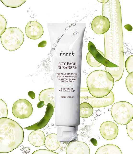 Fresh Soy Face Cleanser in white tube with cucumber and edamame slices. Cosmetic beauty product for skincare on white background.