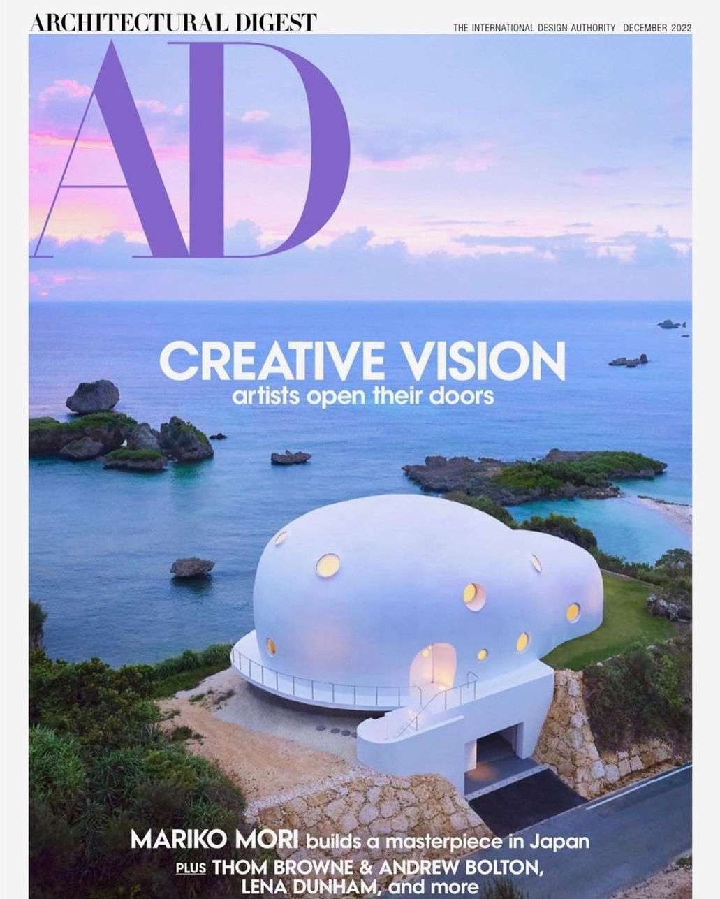 Architectural Digest cover, December 2022, features a unique white dome house near the ocean. Landscape includes the sea and islands.
