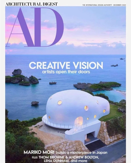Architectural Digest cover, December 2022, features a unique white dome house near the ocean. Landscape includes the sea and islands.