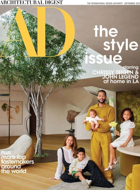 Architectural Digest cover with Chrissy Teigen, John Legend, and their children in a modern home interior, featuring a large tree.