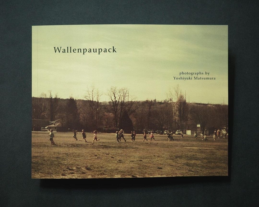 Book cover featuring a vintage-toned photograph of a children's sports game on a field with trees and a cloudy sky in the background.