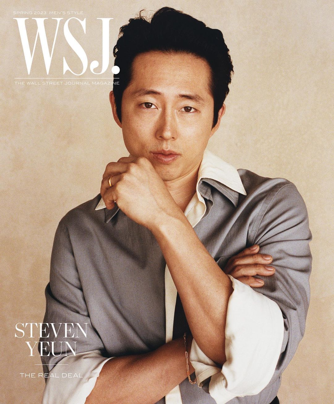 Magazine cover featuring Steven Yeun in a grey button-down shirt, posing confidently with arms crossed. WSJ logo at top of the portrait.