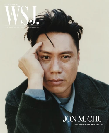 WSJ cover featuring Jon M. Chu looking pensively at the camera with dark hair, wearing a blue collared shirt and a dark green coat.