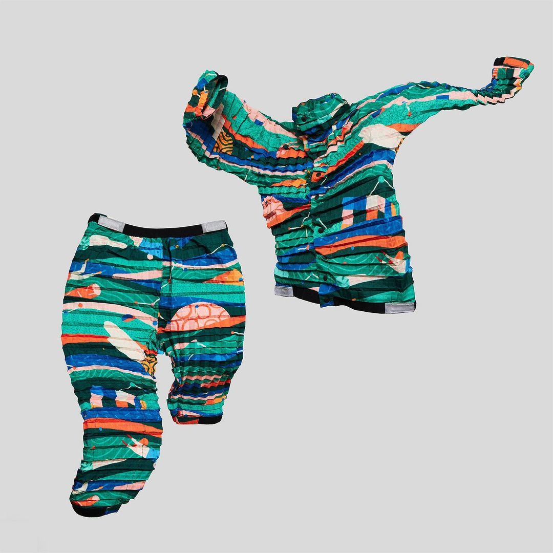 Printed matching outfit: a shirt and pants featuring colorful stripes and shapes against a light gray backdrop.