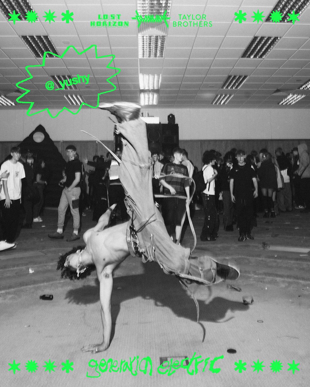 Performer in a handstand in front of a crowd, with green text art. Black and white photograph, low angle, indoor event, crowd background.