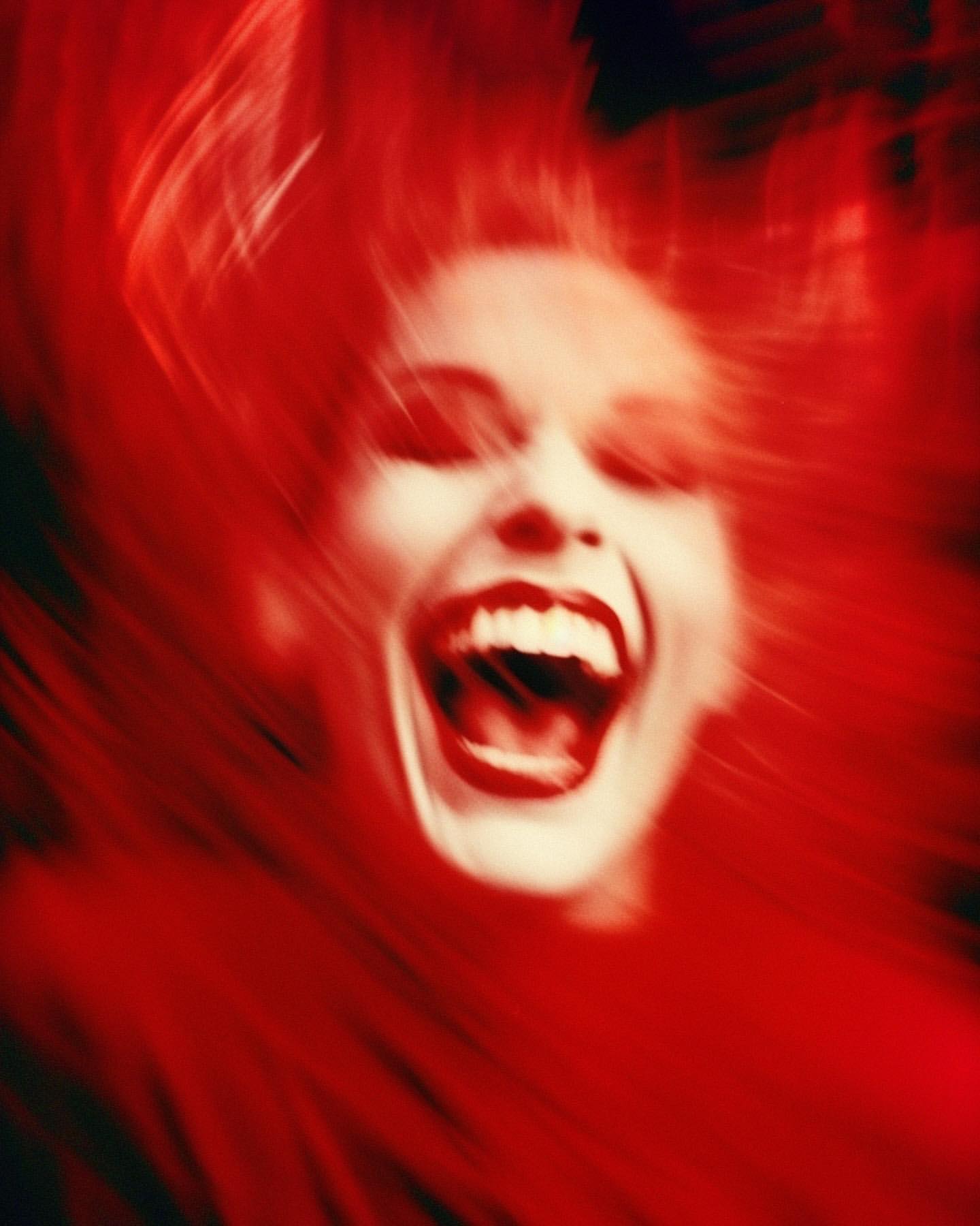 Abstract, blurred close-up of a shouting adult female's face with red lips and fair skin, set against a dark red background with motion blur.