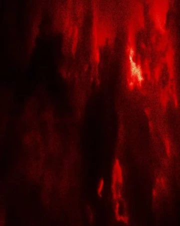 Abstract blurred background with red and black color gradients and shadowy figures blending into the dark, textured backdrop.