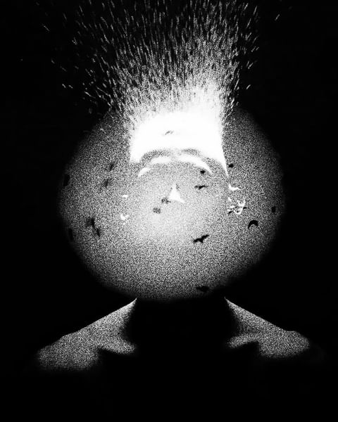 Monochromatic art: A partially visible person stands under a stream of particles in an abstract digital artwork with a dark background.