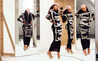 Model wearing a long black and white graphic dress and pink headscarf reflected in multiple studio mirrors captured by Zach Apo-tsang