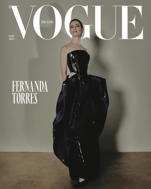 Vogue Brasil cover featuring Fernanda Torres in a dramatic black corset gown, against a muted gray background, fashion editorial.