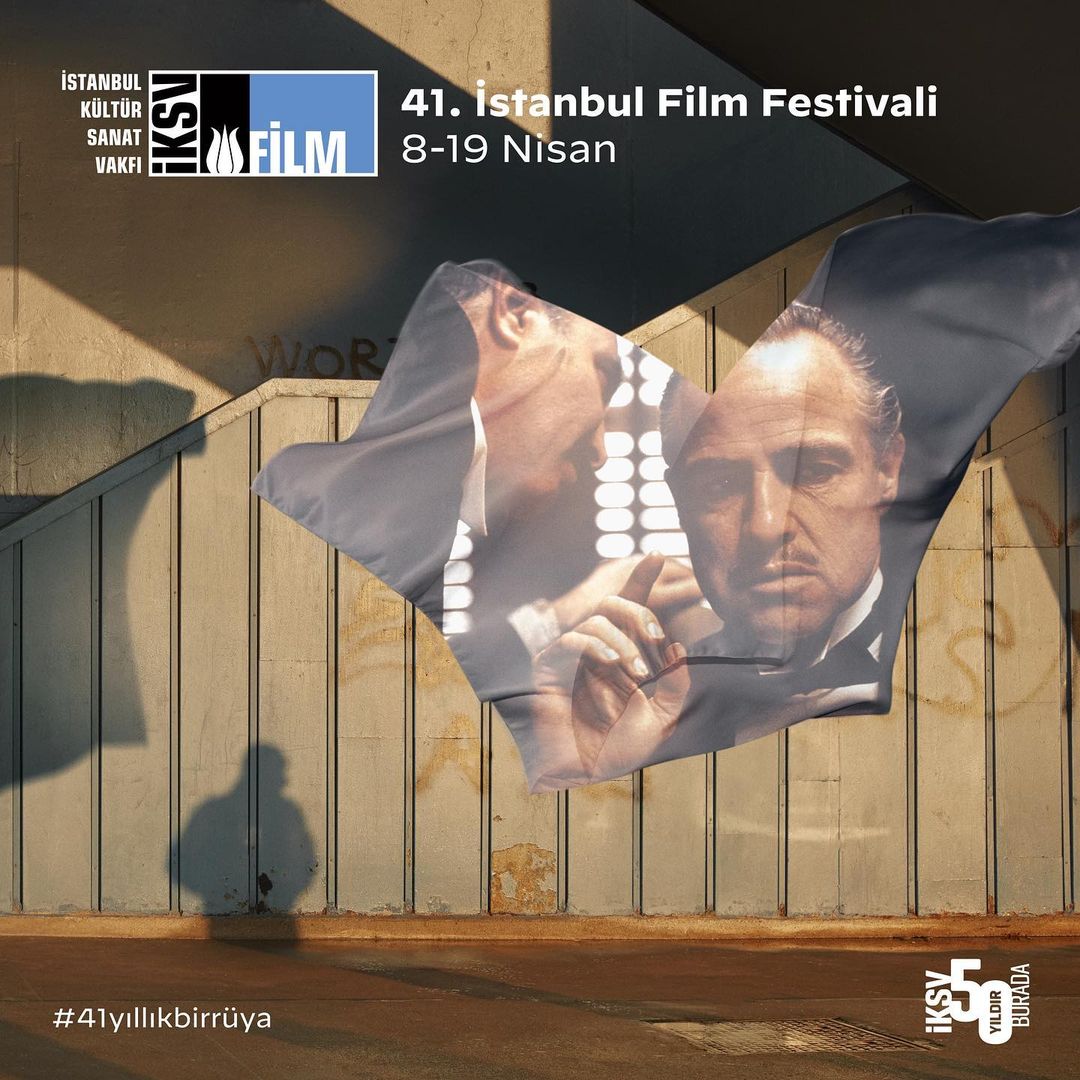 Istanbul Film Festival promotional image featuring a movie poster overlayed on a shadowed wall with visible text and logos.