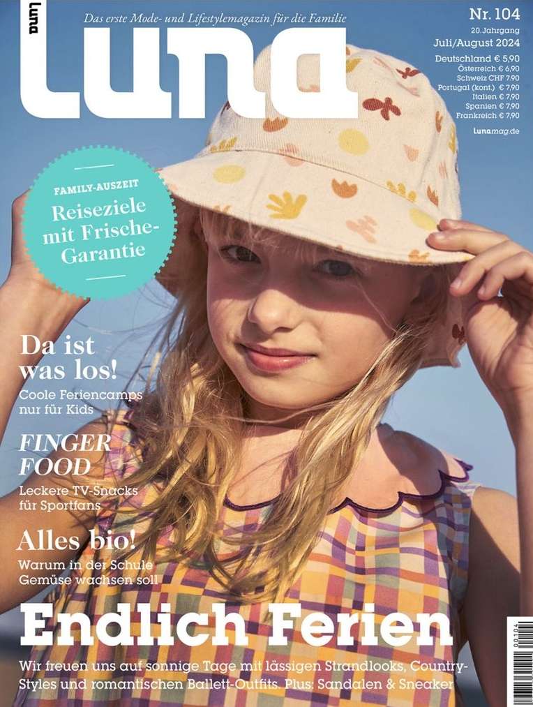 Magazine cover featuring a young girl in a patterned hat and dress against a blurred background, promoting family travel and lifestyle.