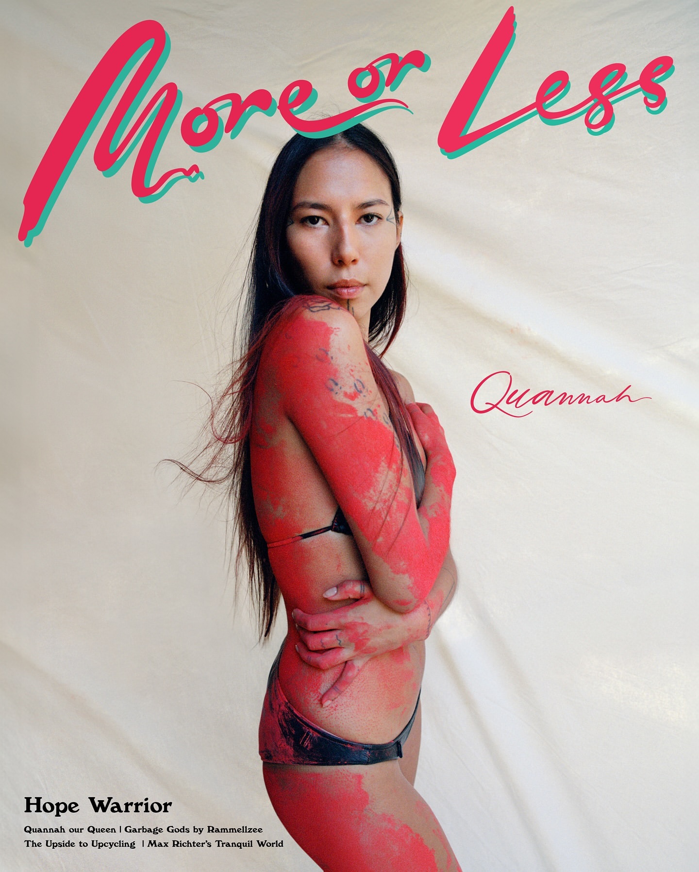 Magazine cover featuring a woman with paint on her body, styled with a black bikini against an off-white backdrop and magazine text.