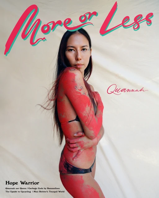 Magazine cover featuring a woman with paint on her body, styled with a black bikini against an off-white backdrop and magazine text.