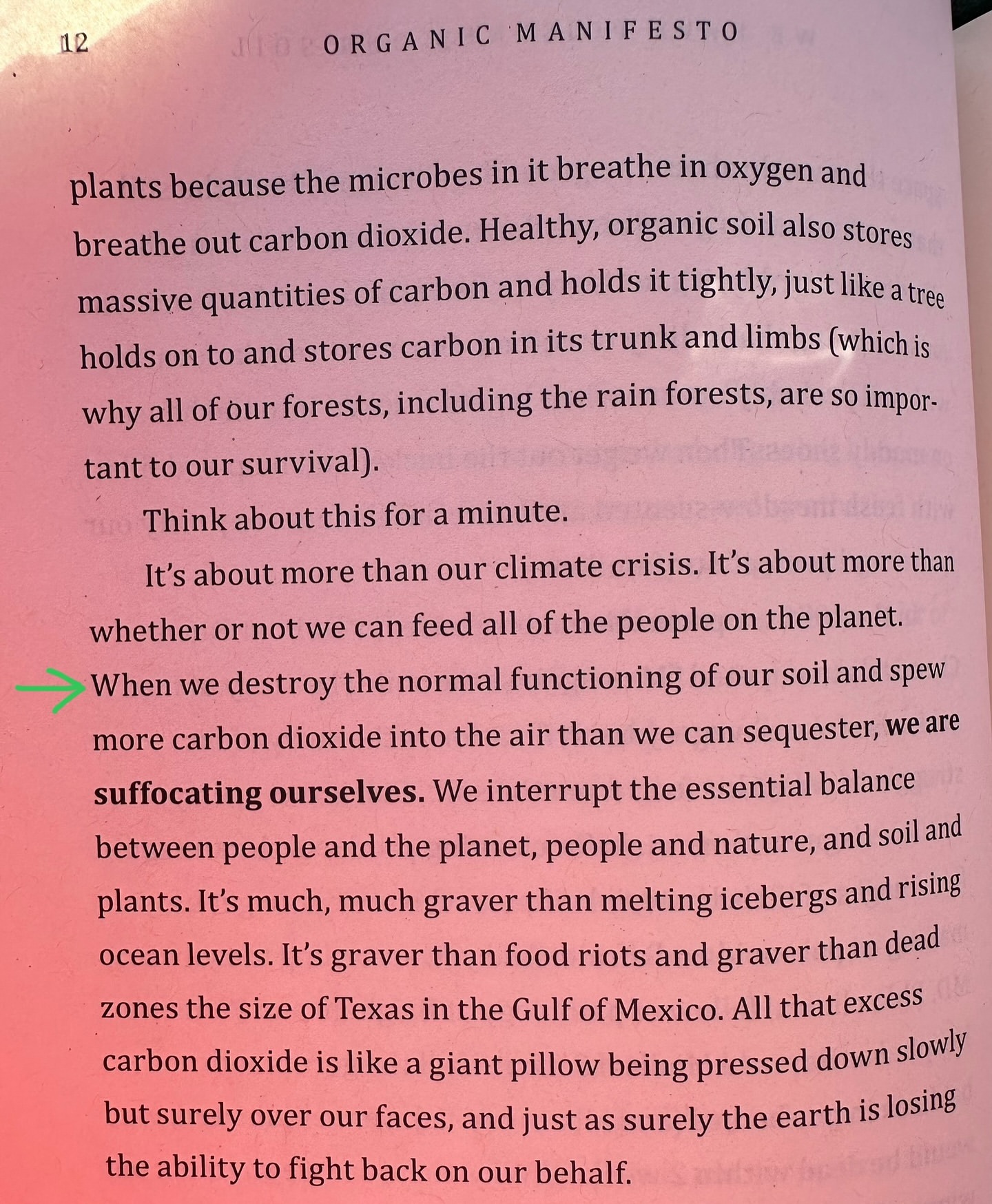 Open book page with text about organic soil, carbon dioxide, and environmental concerns, highlighted by green arrow.