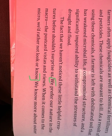 Open book page with text discussing chemical fertilizers, drought, and nature, with green bracketed areas of interest on the left side.