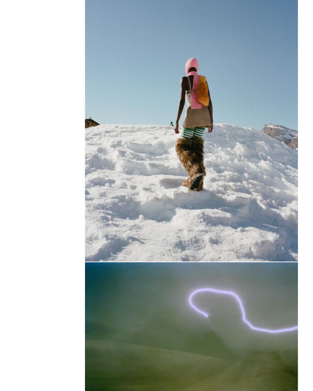 A slender adult female is captured from behind in a medium shot, traversing a snowy terrain under a clear sky, dressed in fur boots.