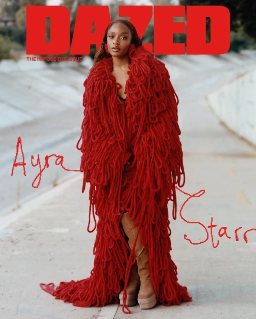 Magazine cover featuring Ayra Starr wearing a red yarn dress, posing outdoors on a concrete path with trees visible in the background.
