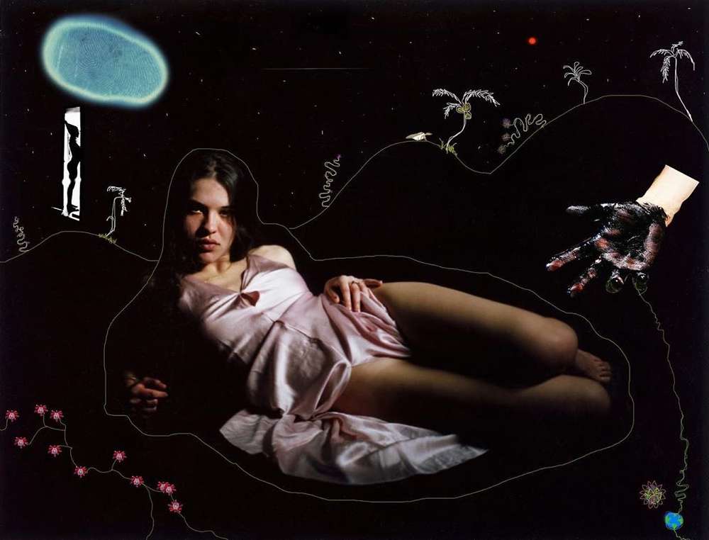 Dreamy art: Woman in pink slip dress lies on a dark background, surrounded by surreal elements like a floating moon and painted hand.