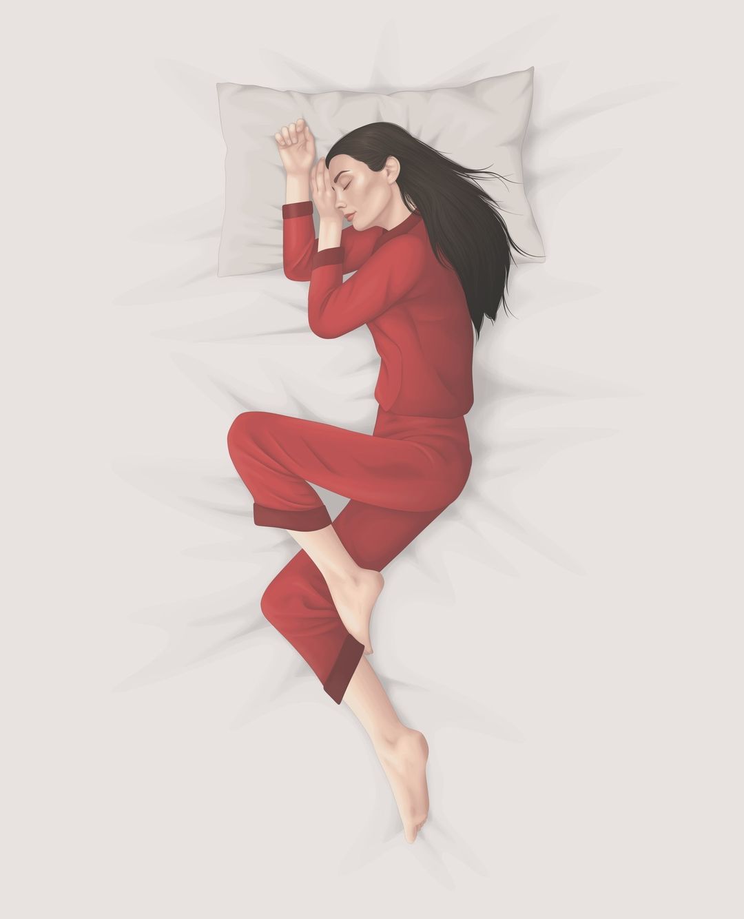 Overhead shot of a serene woman sleeping on white bedding in red pajamas with black hair resting on a pillow. 