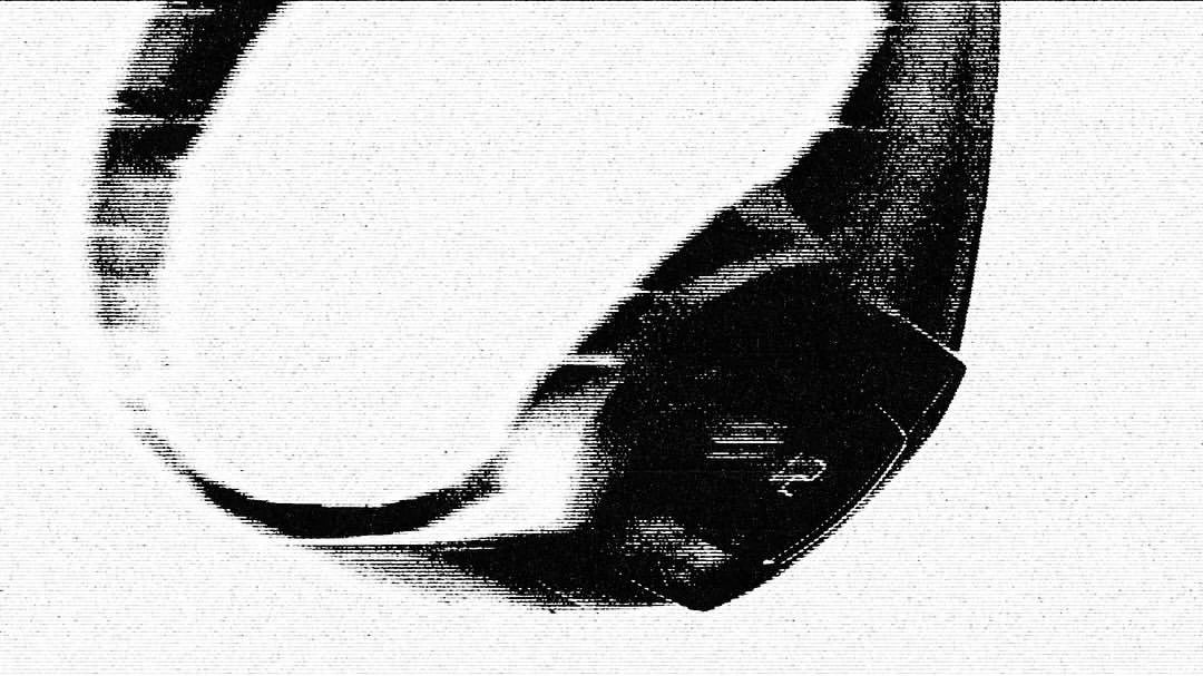 Abstract black-and-white image featuring a curved, reflective surface with dark, indistinct shapes against a bright backdrop.