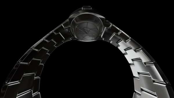 Elevated shot of a futuristic-style metal watch and bracelet, emphasizing its modern design and structural components against a stark black backdrop.