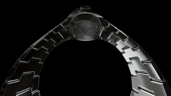 Elevated shot of a futuristic-style metal watch and bracelet, emphasizing its modern design and structural components against a stark black backdrop.