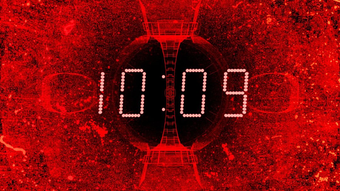 Digital display showing 10:09 in bright white against a red and black abstract background with geometric shapes.