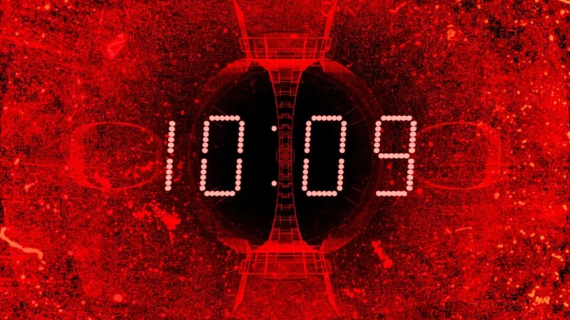 Digital display showing 10:09 in bright white against a red and black abstract background with geometric shapes.