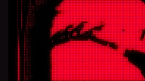Abstract digital display with geometric patterns and bold red and black color scheme, creating a visually striking and modern aesthetic.