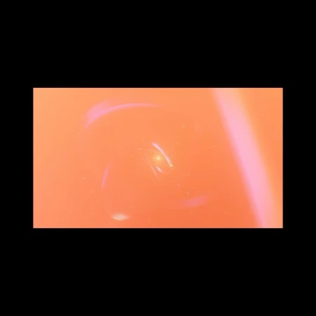 Abstract blurred background with orange color and a bright light in the center, creating a dynamic and textured visual effect.