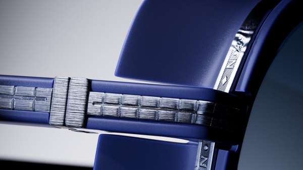 Macro shot of a blue and silver watch band featuring a metallic woven pattern and silver accents, highlighting texture and craftsmanship.