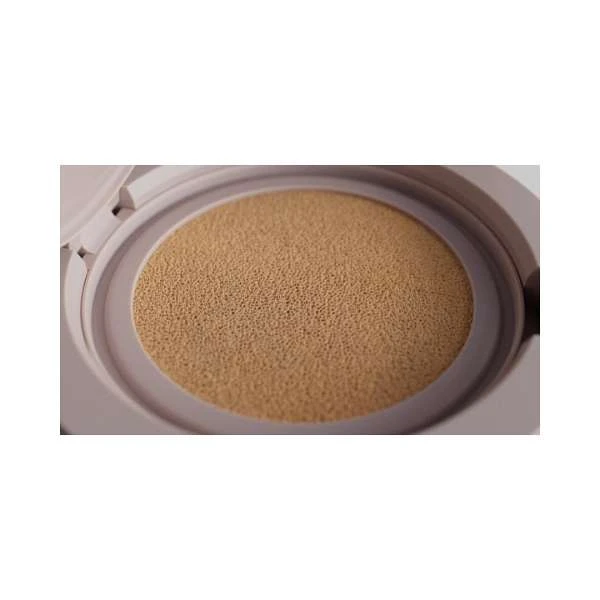Tan-colored cushion compact case, open, showing the beige-colored sponge insert, in a studio setting against a white background.