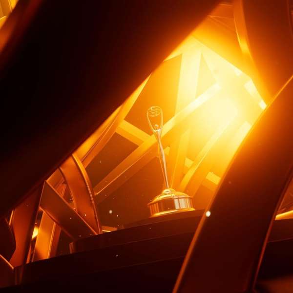 Golden trophy on a platform, dramatically lit against a golden, geometric background. The shot emphasizes the trophy and awards ceremony.