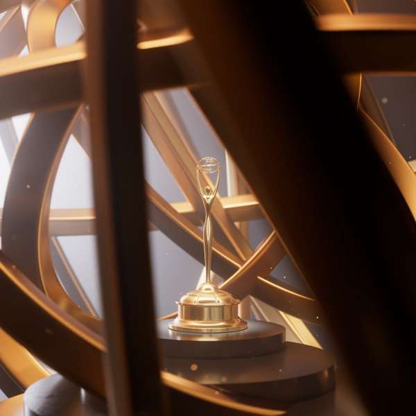 Elegant golden trophy on a tiered black stand with a complex, abstract background of golden geometric shapes and diffused lighting.