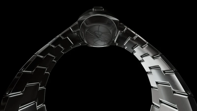 Close-up of a sleek, metal wristwatch with a distinctive band, set against a stark black background that highlights its intricate design.