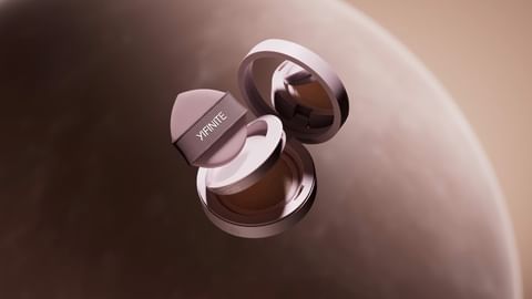 Cosmetic foundation case and sponge applicator floating in a studio shot. The brand name YIFINITE is printed on the sponge applicator.
