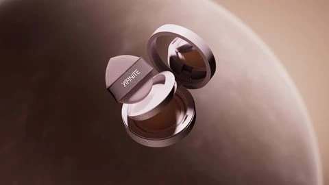 Cosmetic foundation case and sponge applicator floating in a studio shot. The brand name YIFINITE is printed on the sponge applicator.