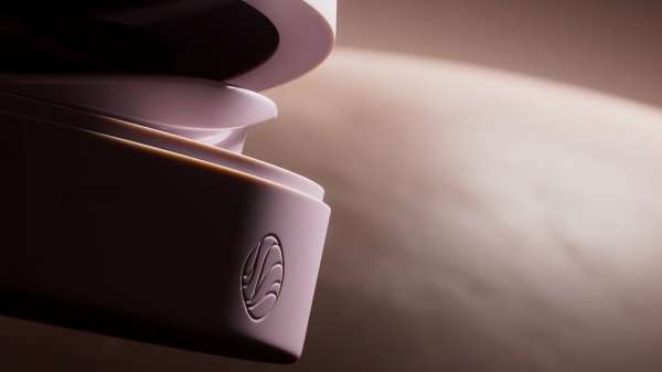 Close-up of a modern light-lavender container with the brand's wave-like logo against a blended light-brown background in soft lighting.