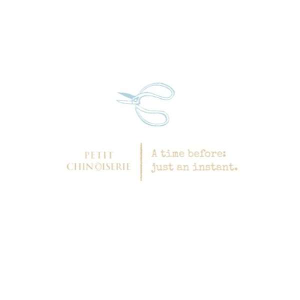 Elegant graphic design featuring a pair of light blue scissors above stylized text, conveying a sense of classic style and sophistication.
