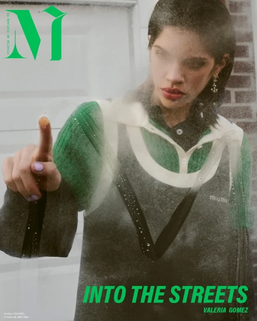 Magazine cover shot of a young adult female model wearing a green and black top with the magazine's logo and text overlayed.
